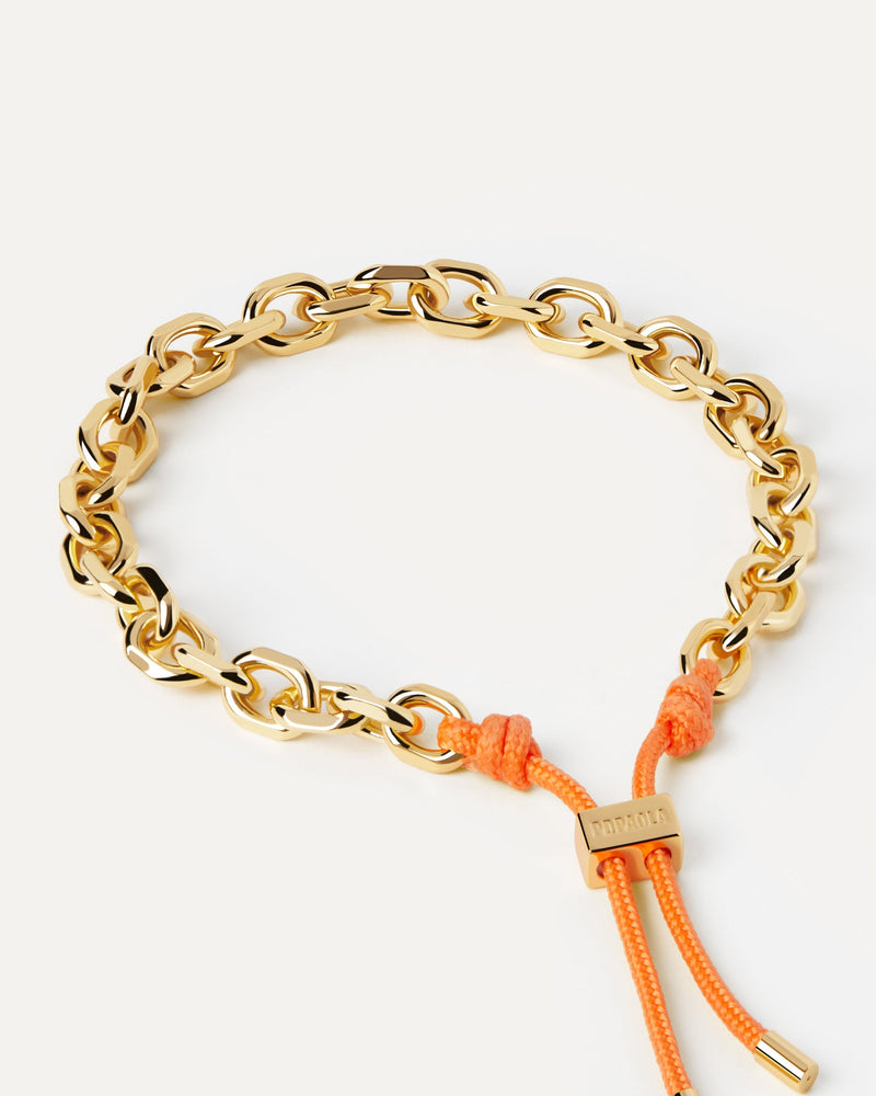 Golden chain bracelet with an orange rope adjustable sliding clasp