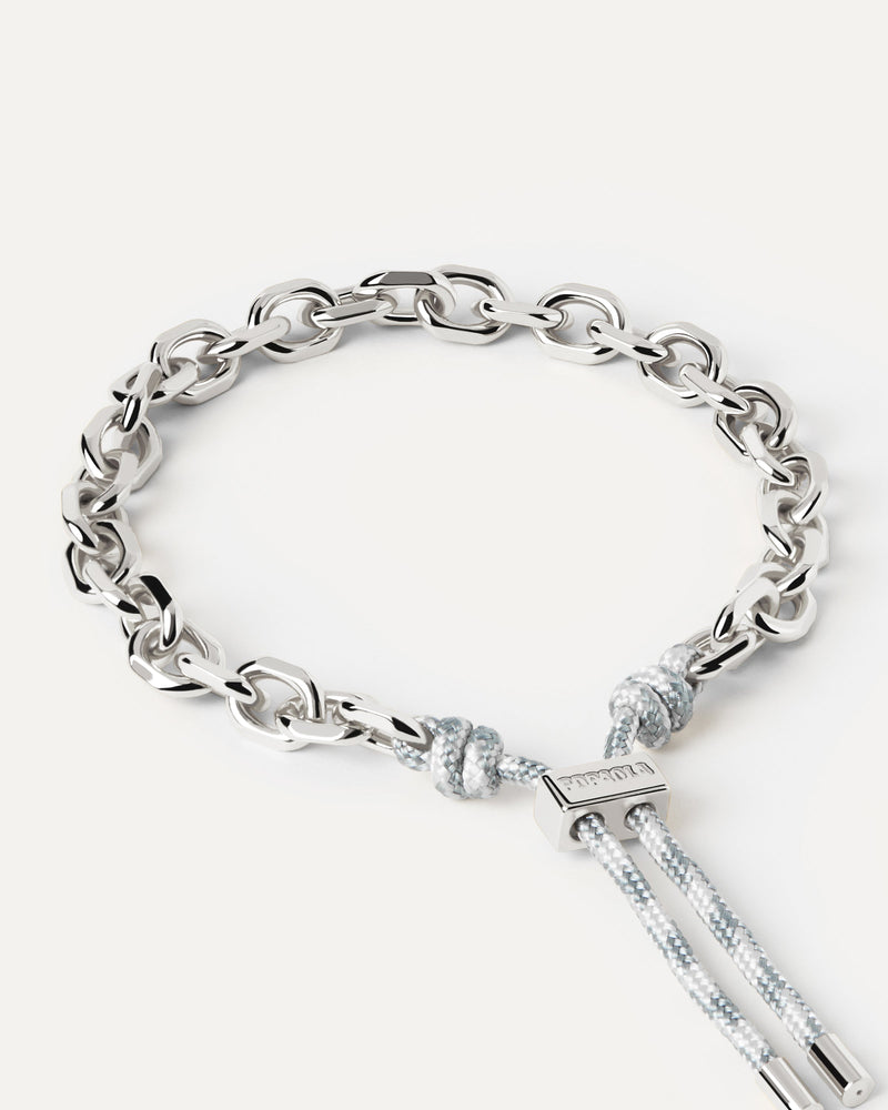 Silver tone chain bracelet with a blue and white rope adjustable sliding clasp