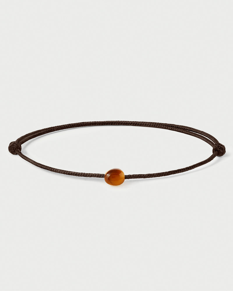 Bracciale con cordino nero regolabile con pietra marrone.