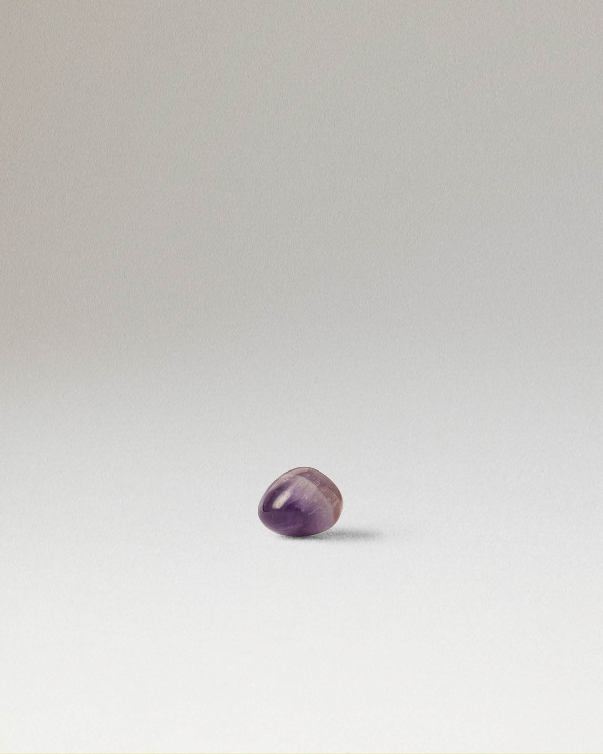 Fluid-Ohrpiercing mit unregelmäßigen lila runden Edelstein
