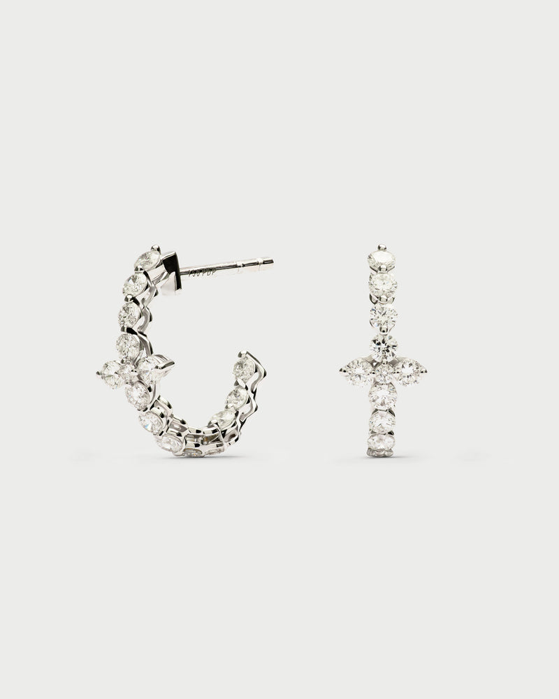 Small white gold hoop earrings with a lab-grown diamond flower accent.