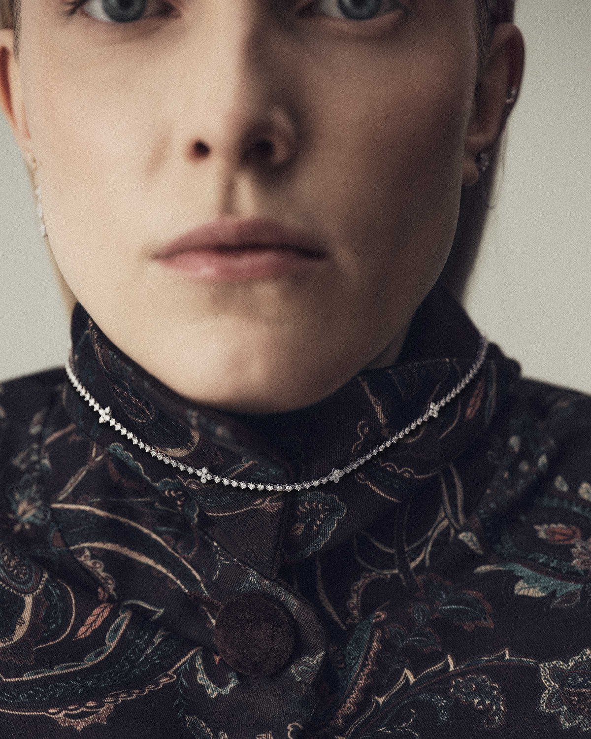 White gold necklace with lab-grown diamonds and floral accents.