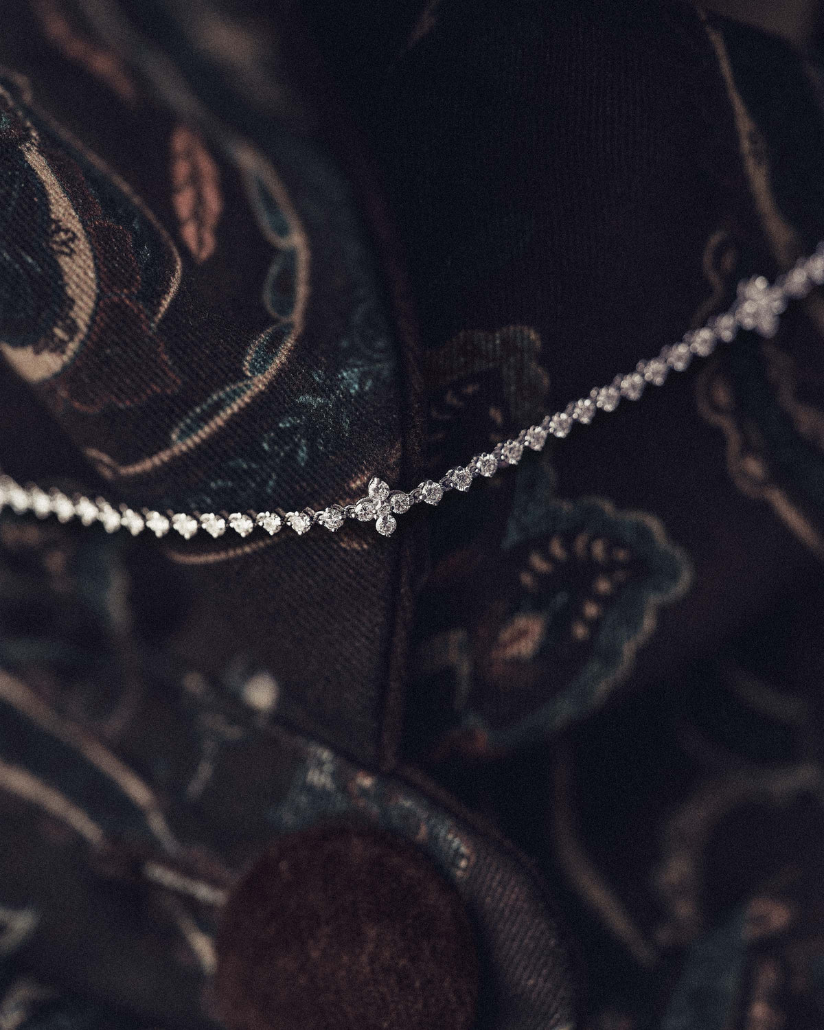 White gold necklace with lab-grown diamonds and floral accents.