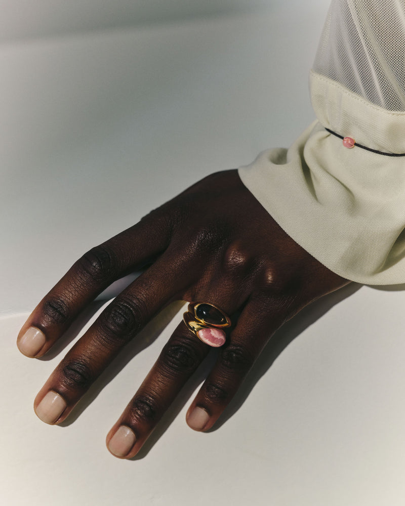 Fluid gold-plated silver signet ring with a pink stone.