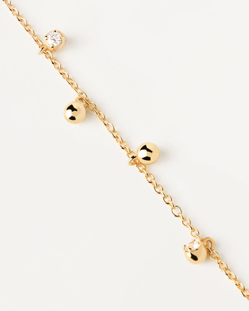 Gold-plated silver bracelet with small zirconia and ball pendants